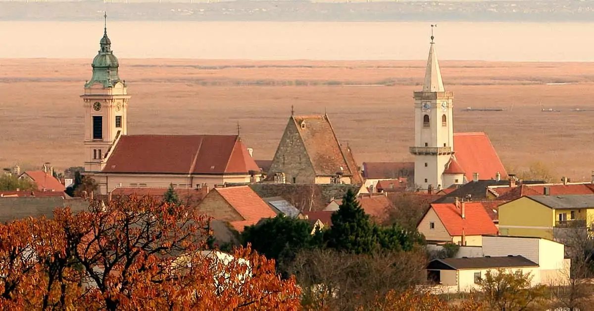 Rust's two towers above the red roofs, the reed belt and the shallow lake running to the horizon
